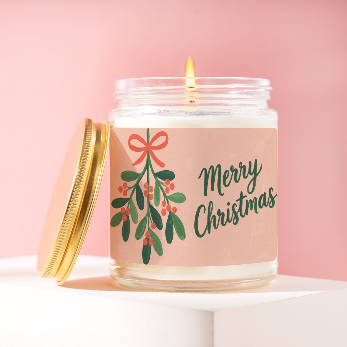 Merry Christmas 9 oz soy candle with a brushed gold lid by James Wax