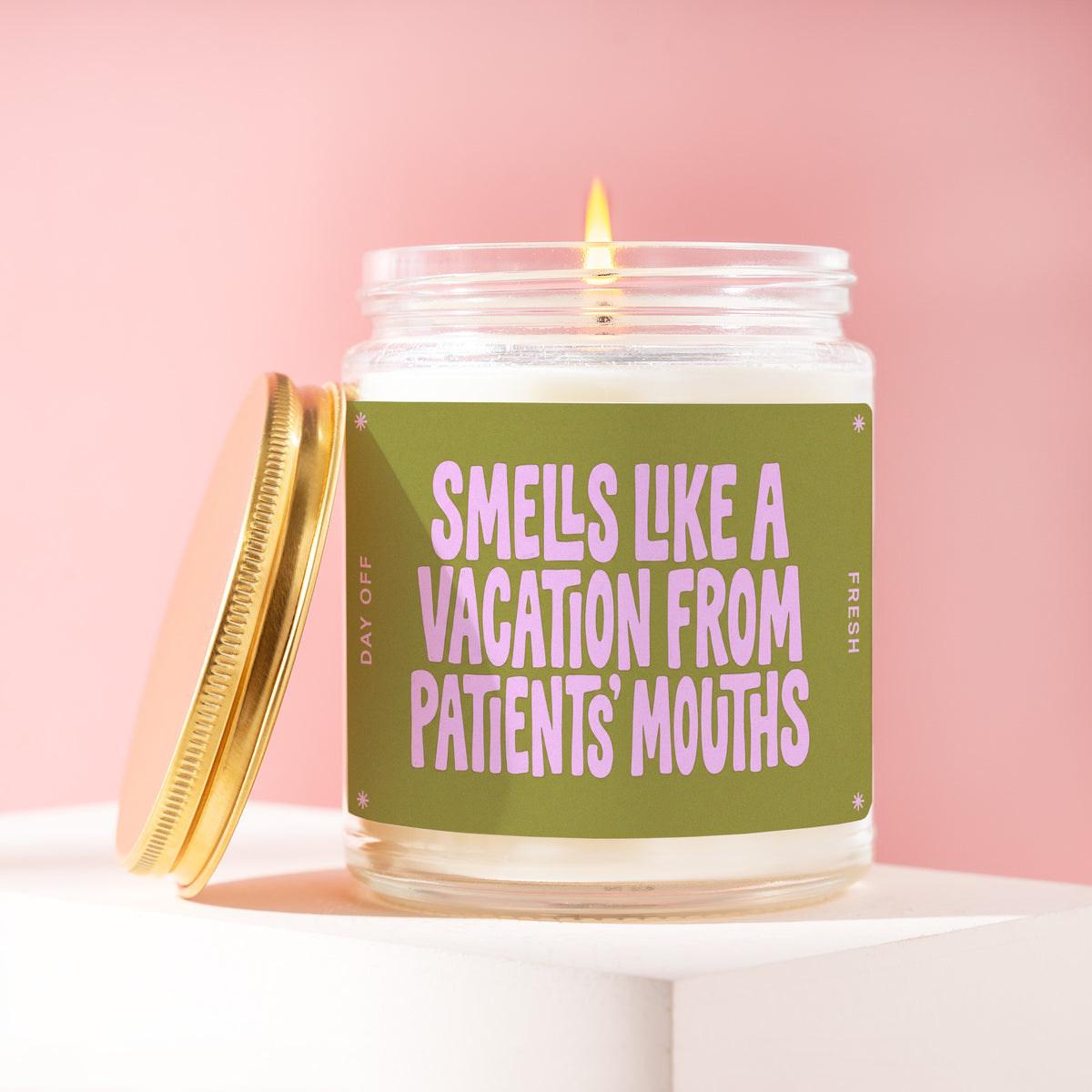 Smells Like A Vacation From Patients' Mouths 9 oz soy candle with a brushed gold lid by James Wax