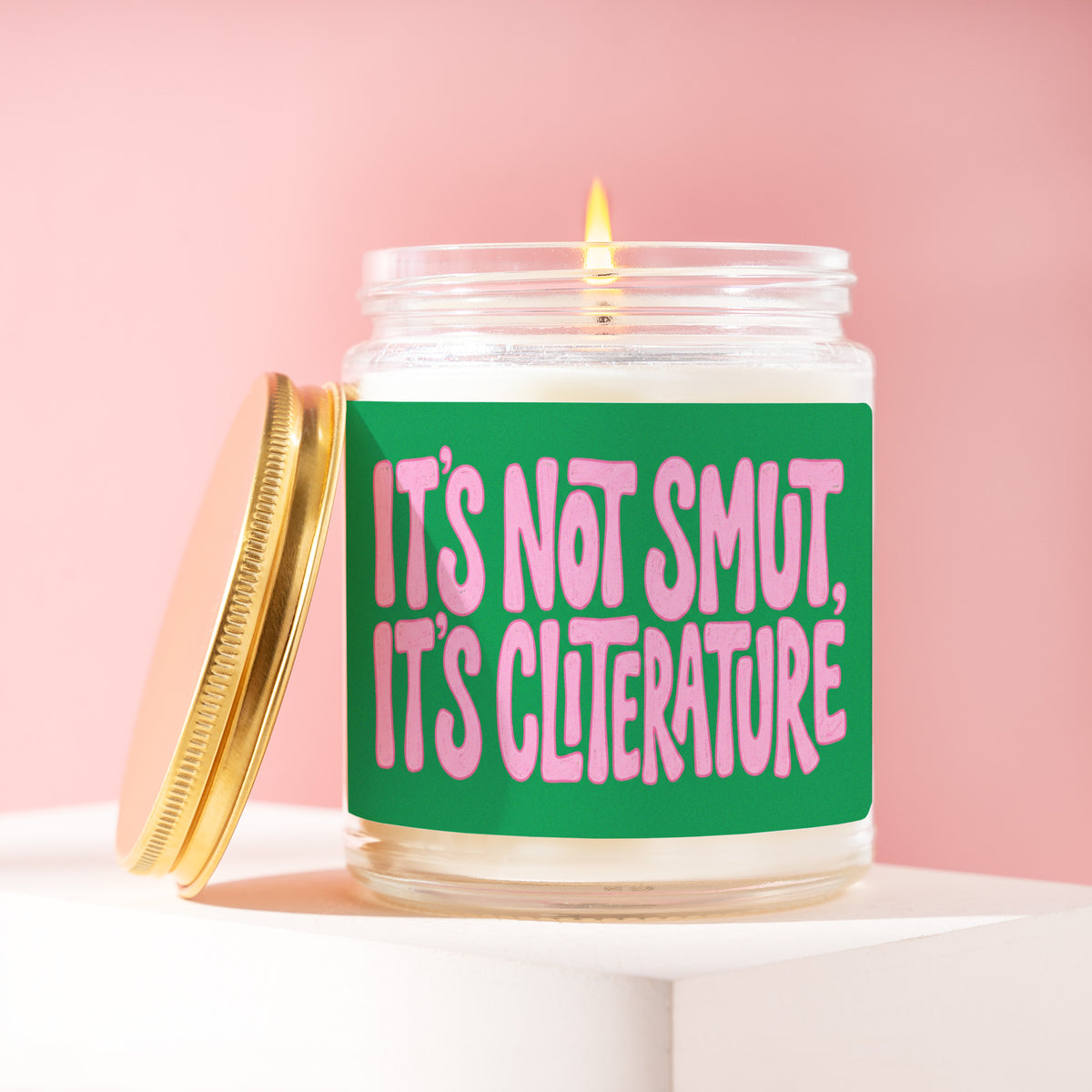 It's Not Smut, It's Cliterature 9 oz soy candle with a brushed gold lid by James Wax