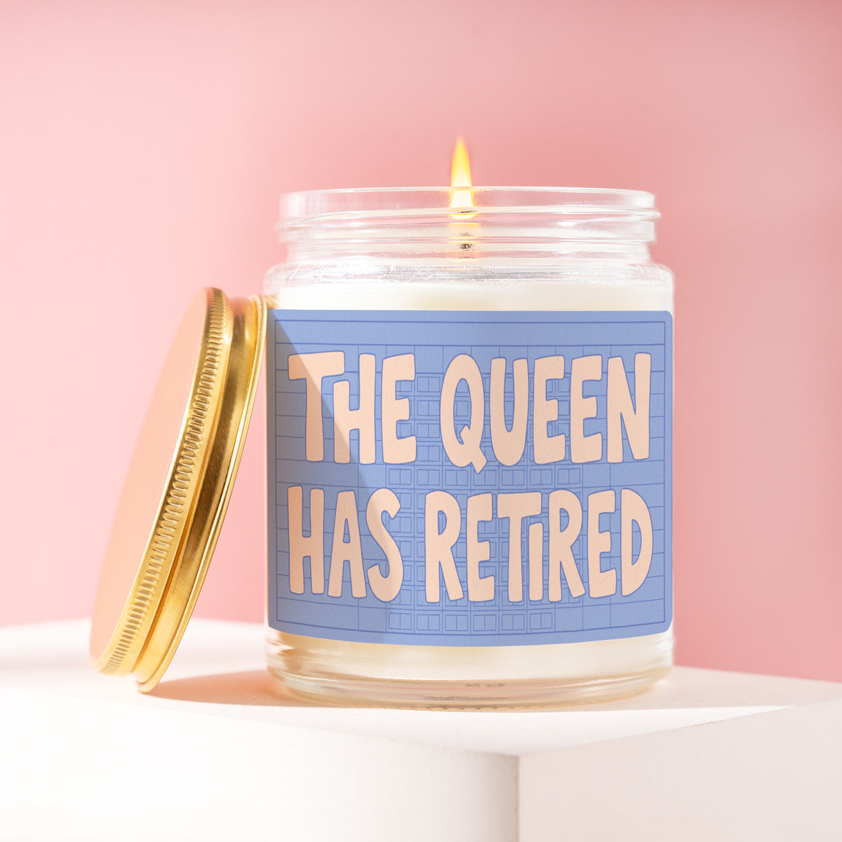 The Queen Has Retired 9 oz soy candle with a brushed gold lid by James Wax