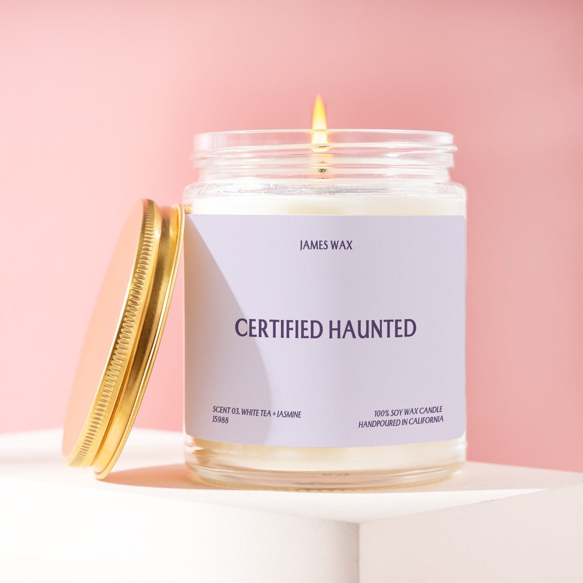 Certified Haunted 9 oz soy candle with a brushed gold lid by James Wax