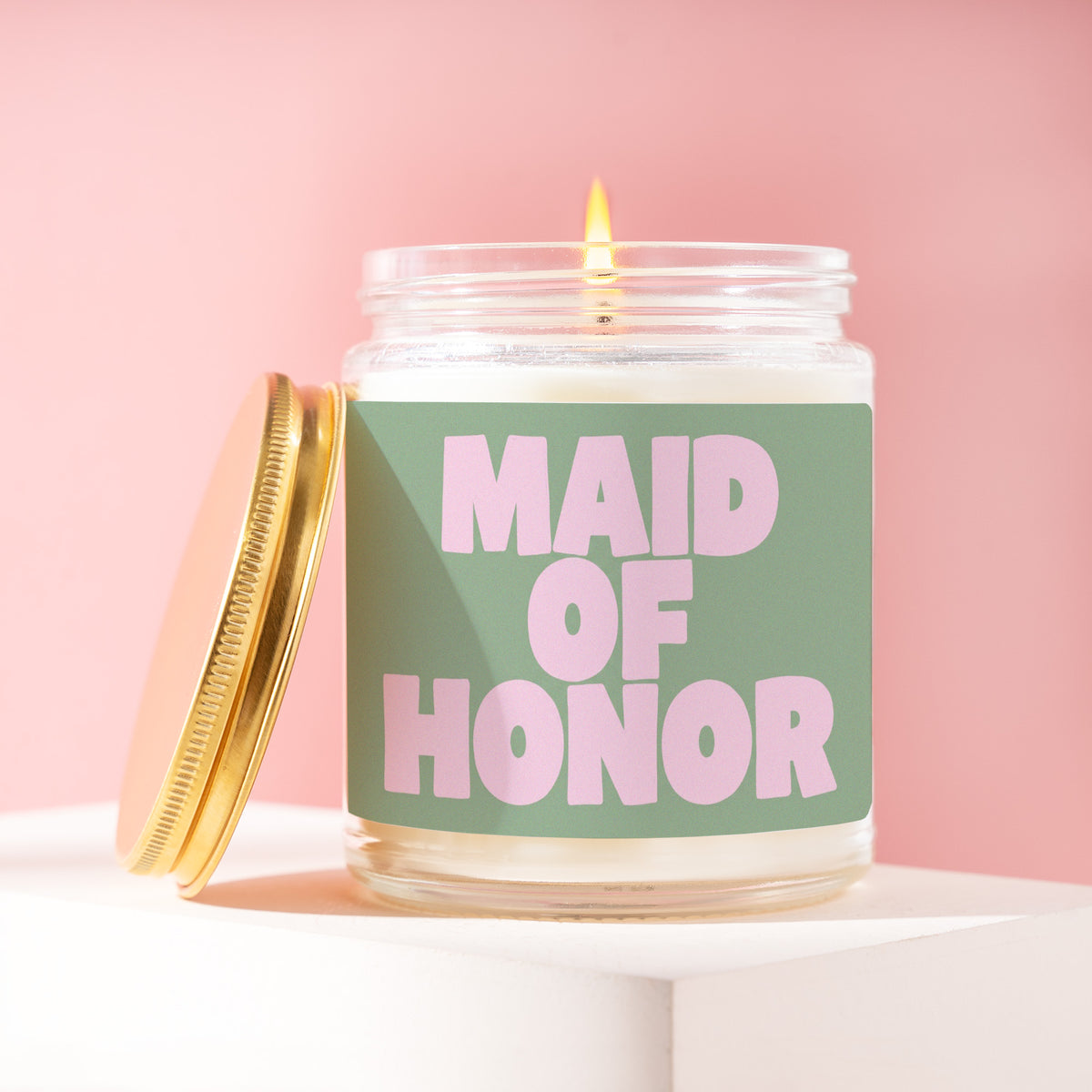 Maid Of Honor 9 oz soy candle with a brushed gold lid by James Wax