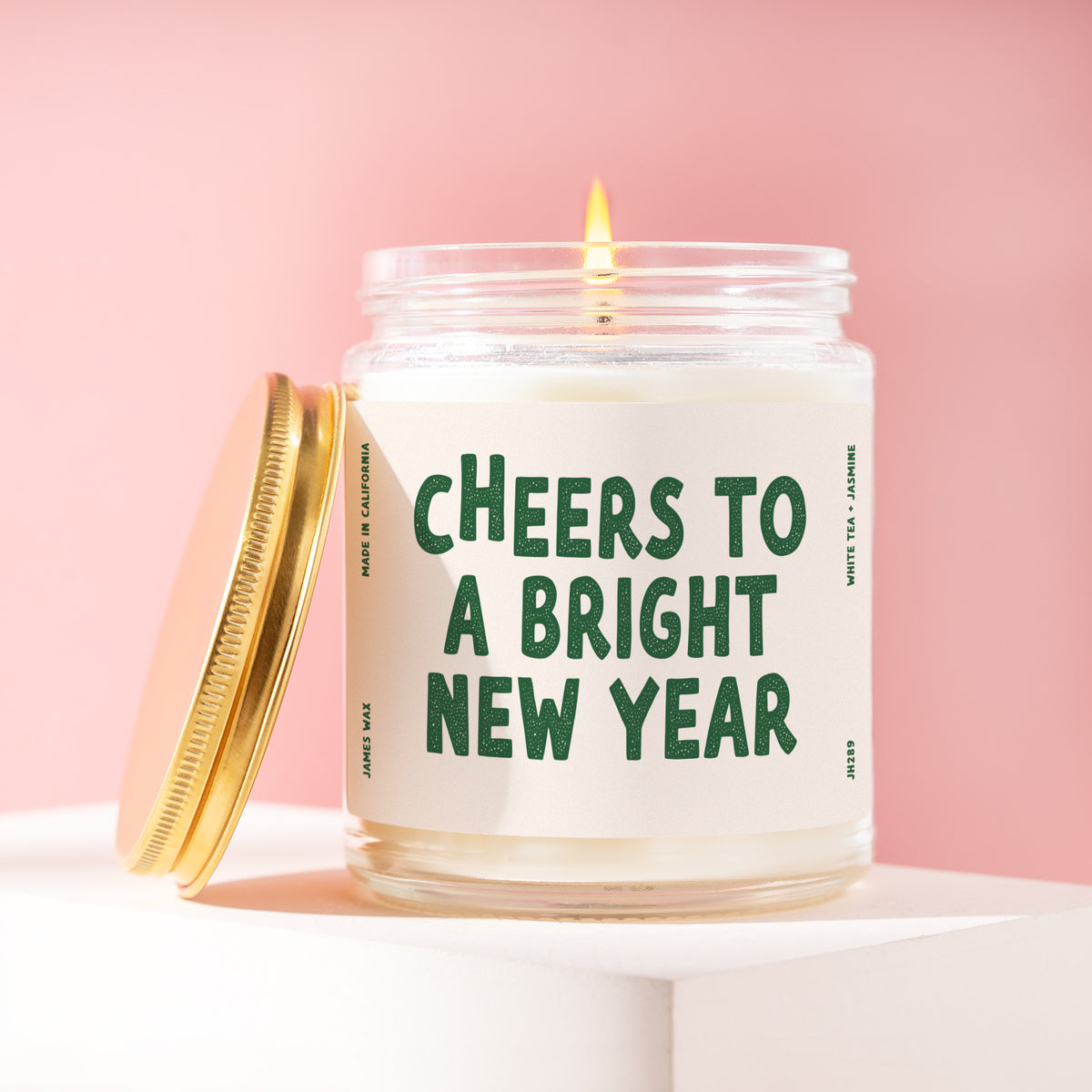 Cheers To A Bright New Year 9 oz soy candle with a brushed gold lid by James Wax