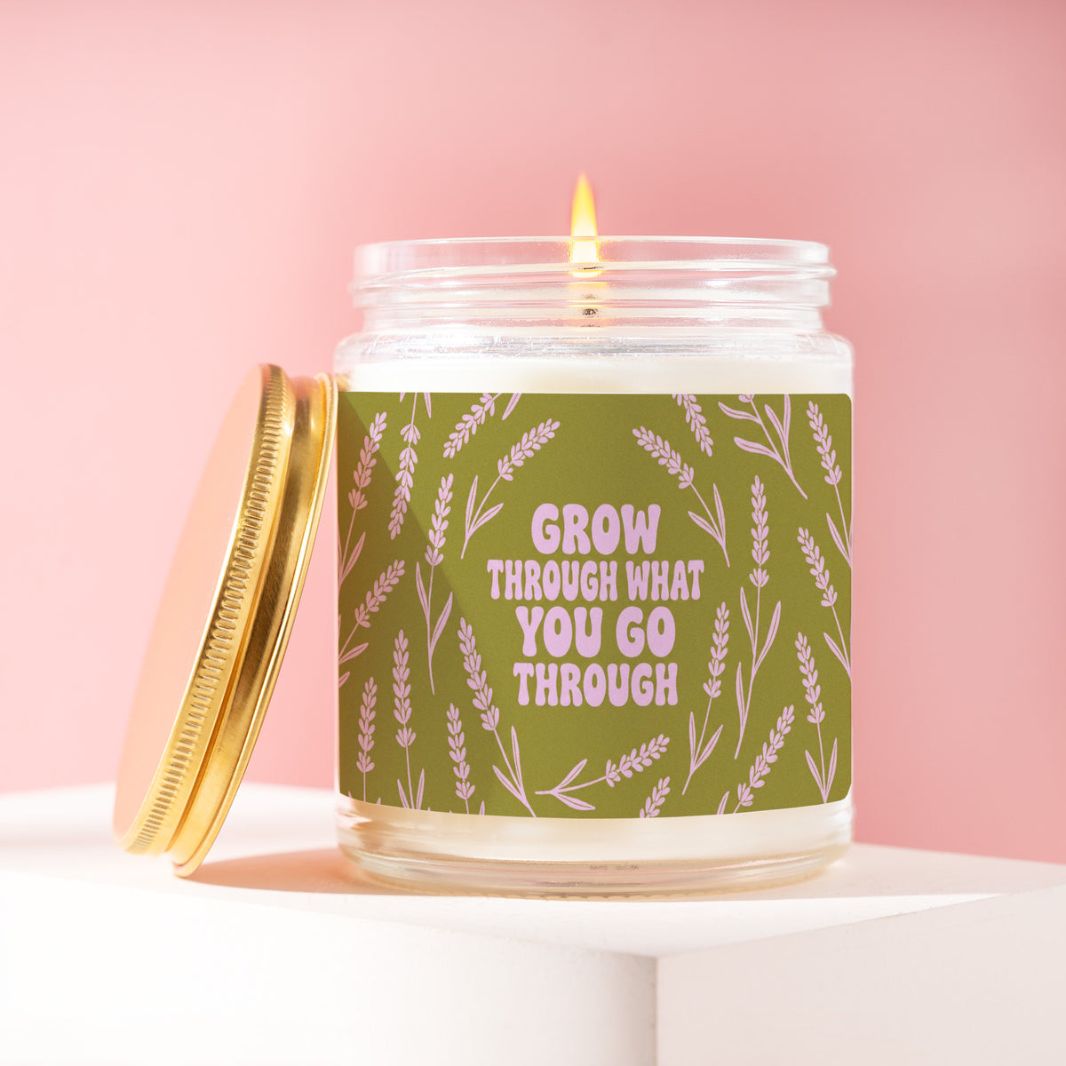 Grow Through What You Go Through 9 oz soy candle with a brushed gold lid by James Wax