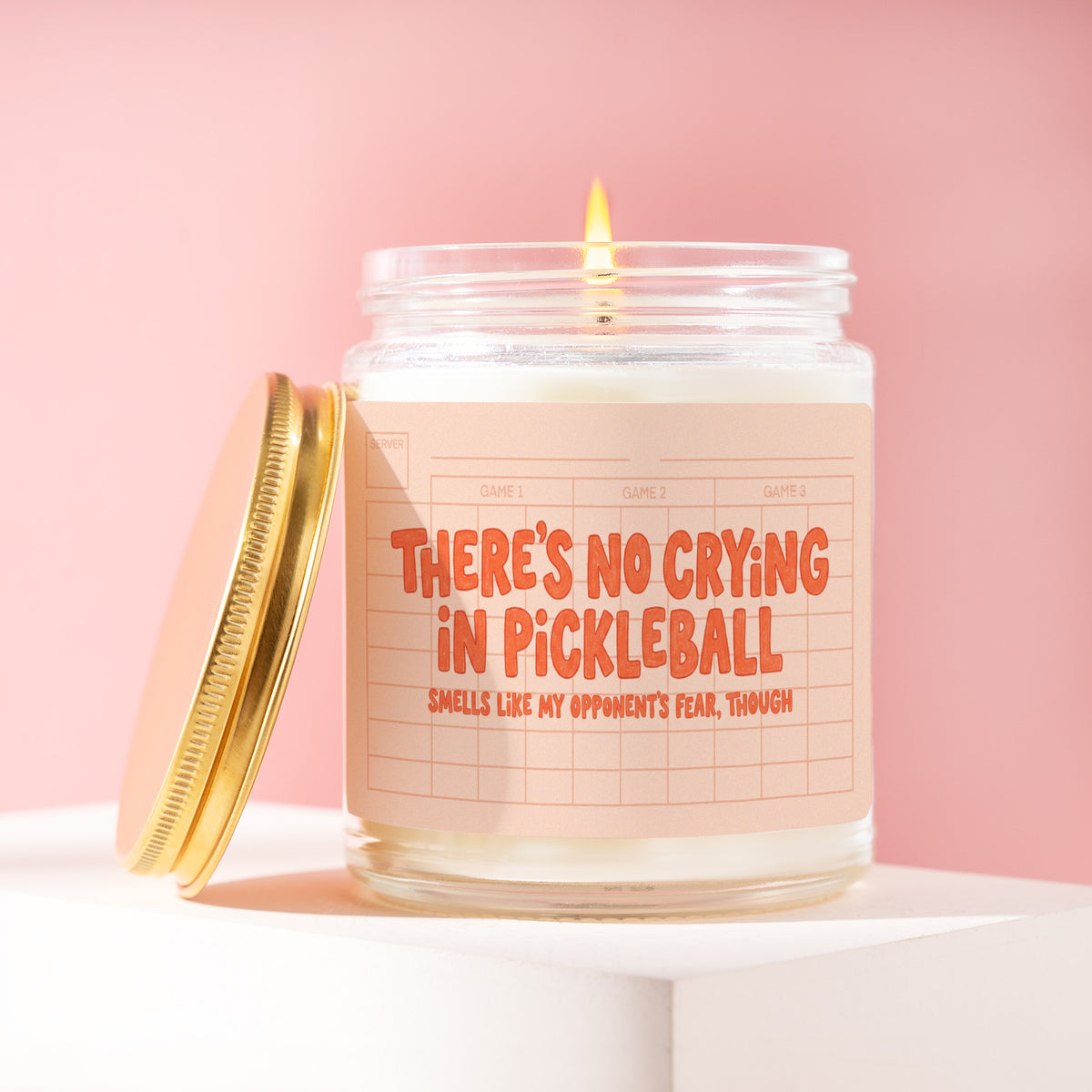 There's No Crying In Pickleball. Smells Like My Opponents' Fear Though 9 oz soy candle with a brushed gold lid by James Wax