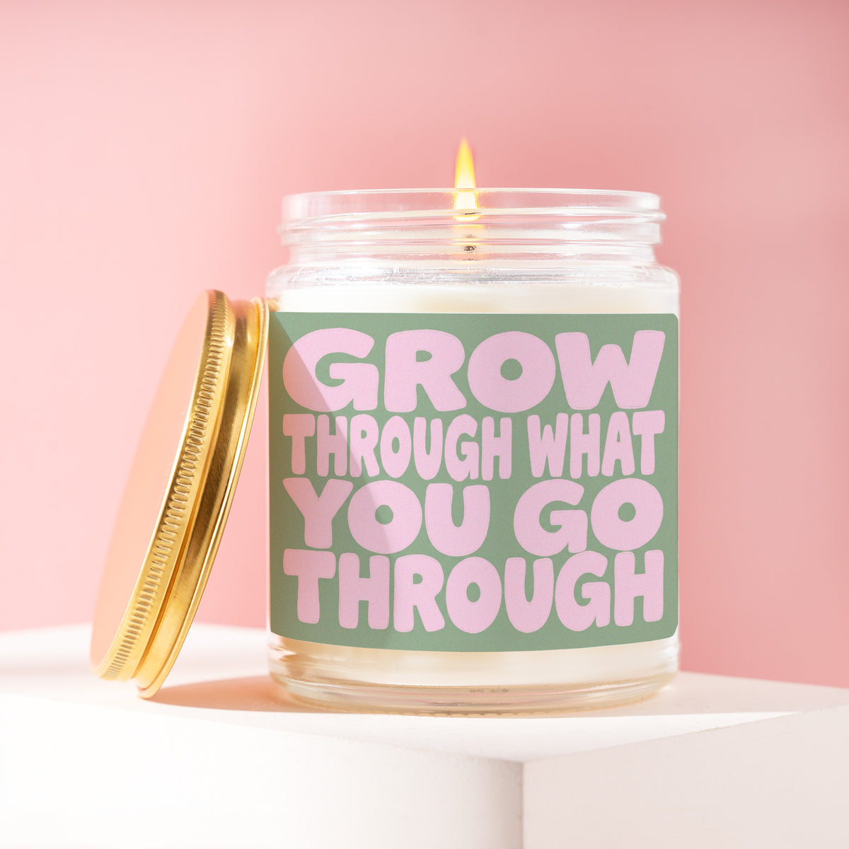 Grow Through What You Go Through 9 oz soy candle with a brushed gold lid by James Wax