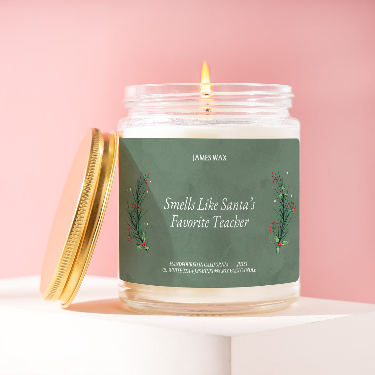 Smells Like Santa's Favorite Teacher 9 oz soy candle with a brushed gold lid by James Wax