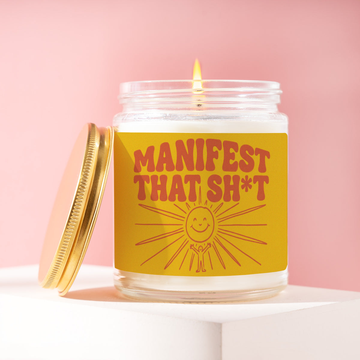 Manifest That Sh*t 9 oz soy candle with a brushed gold lid by James Wax