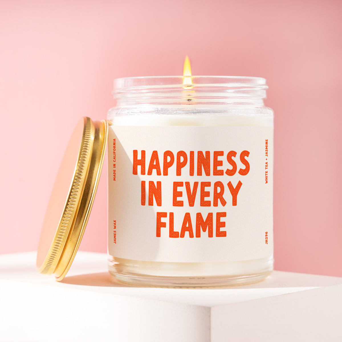 Happiness In Every Flame 9 oz soy candle with a brushed gold lid by James Wax