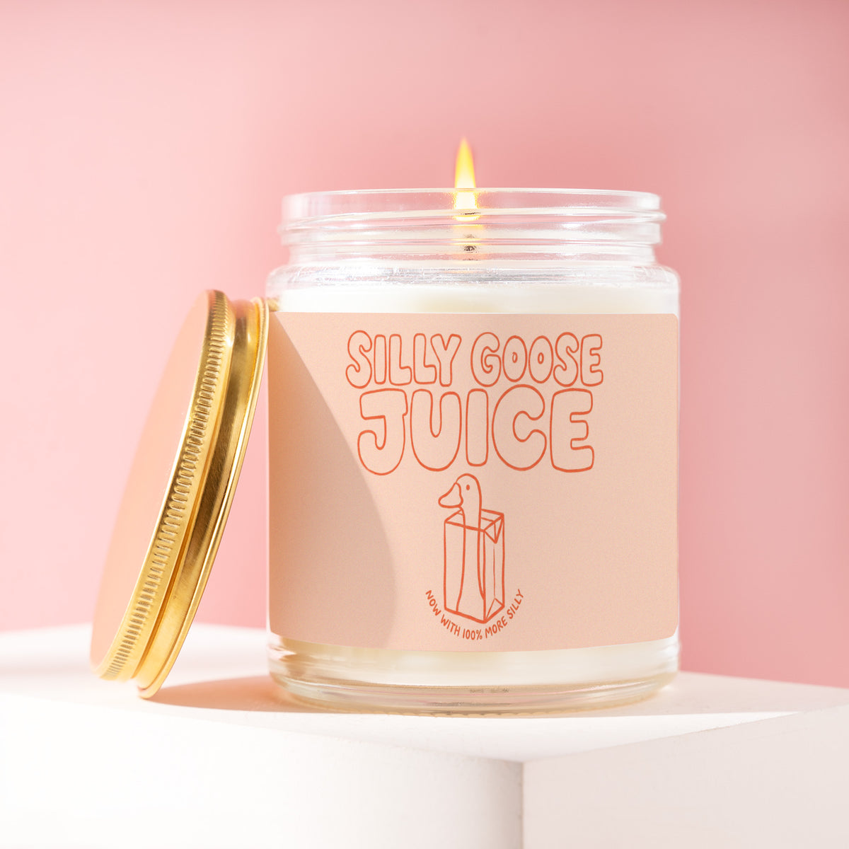 Silly Goose Juice 9 oz soy candle with a brushed gold lid by James Wax