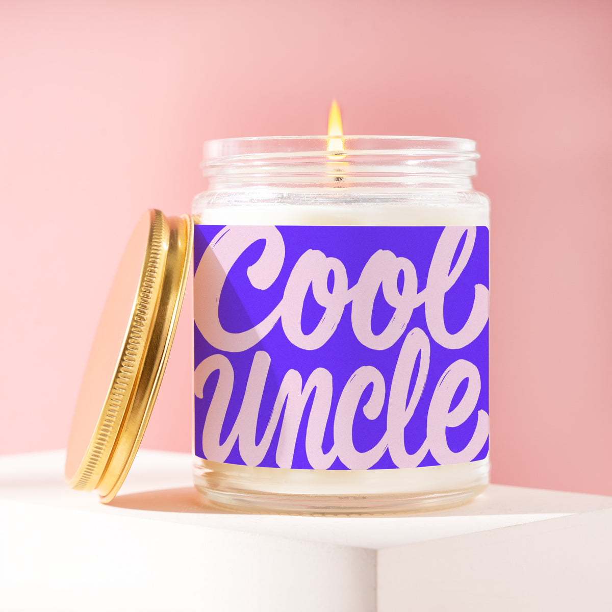 Cool Uncle 9 oz soy candle with a brushed gold lid by James Wax