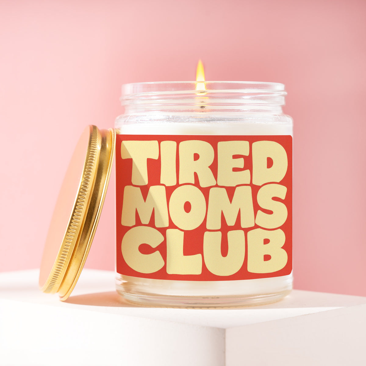 Tired Moms Club 9 oz soy candle with a brushed gold lid by James Wax