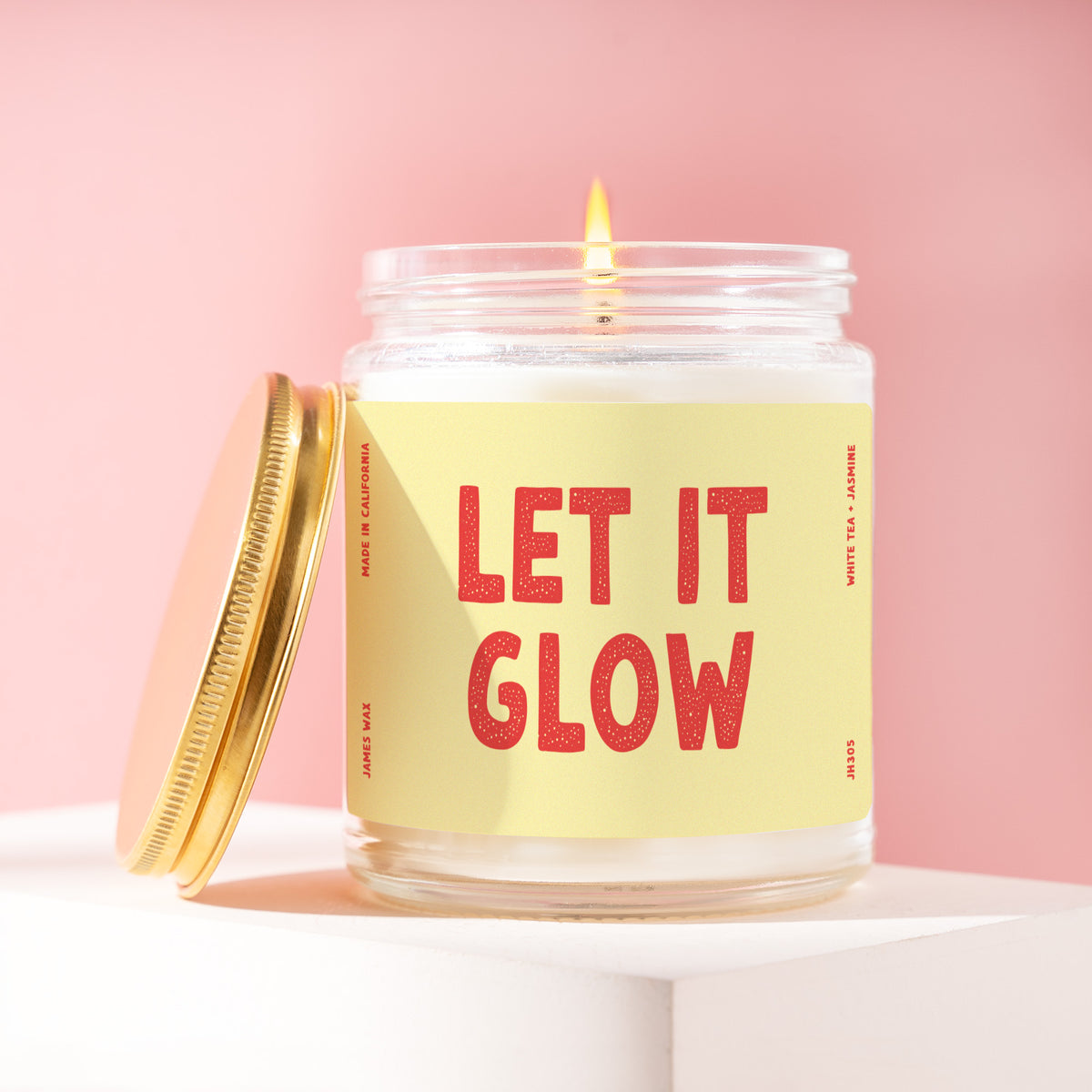 Let It Glow 9 oz soy candle with a brushed gold lid by James Wax