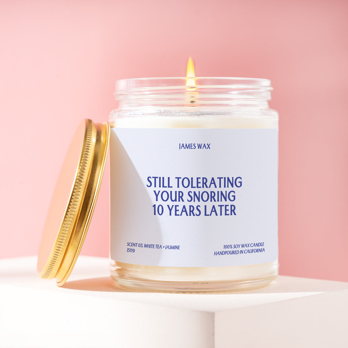 Still Tolerating Your Snoring 10 Years Later 9 oz soy candle with a brushed gold lid by James Wax