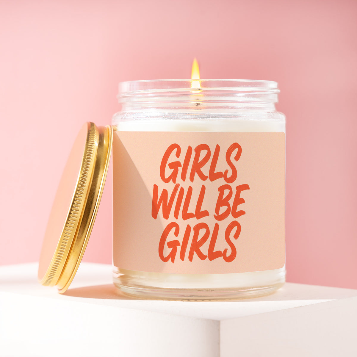 Girls Will Be Girls 9 oz soy candle with a brushed gold lid by James Wax