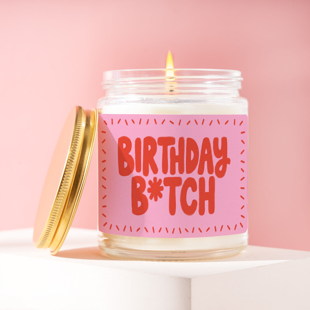 Birthday B*tch 9 oz soy candle with a brushed gold lid by James Wax