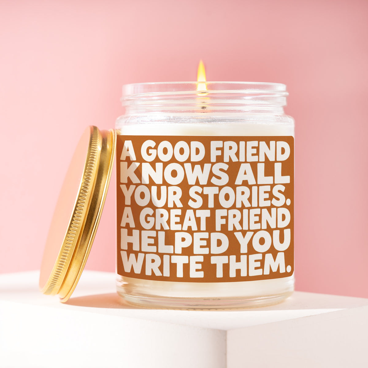 A Good Friend Knows All Your Stories. A Great Friend Helped You Write Them. 9 oz soy candle with a brushed gold lid by James Wax