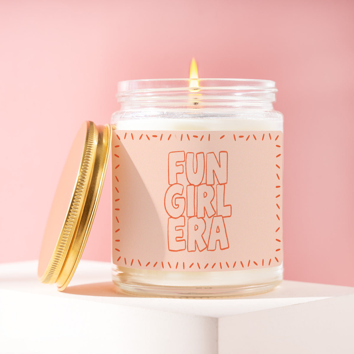 Fun Girl Era 9 oz soy candle with a brushed gold lid by James Wax