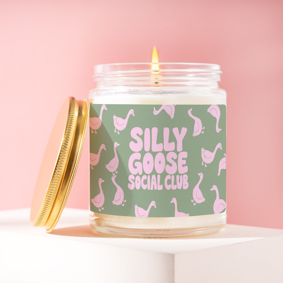 Silly Goose Social Club 9 oz soy candle with a brushed gold lid by James Wax
