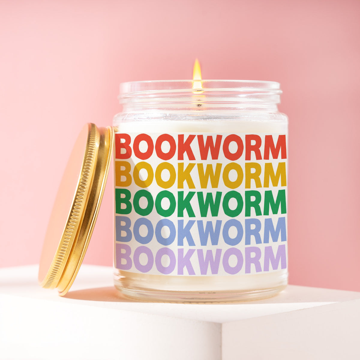 Bookworm 9 oz soy candle with a brushed gold lid by James Wax
