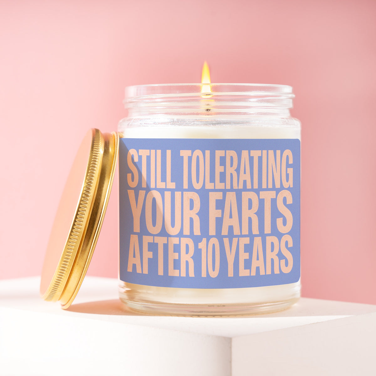 Still Tolerating Your Farts After 10 Years 9 oz soy candle with a brushed gold lid by James Wax