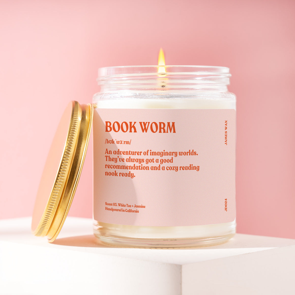 Book Worm 9 oz soy candle with a brushed gold lid by James Wax