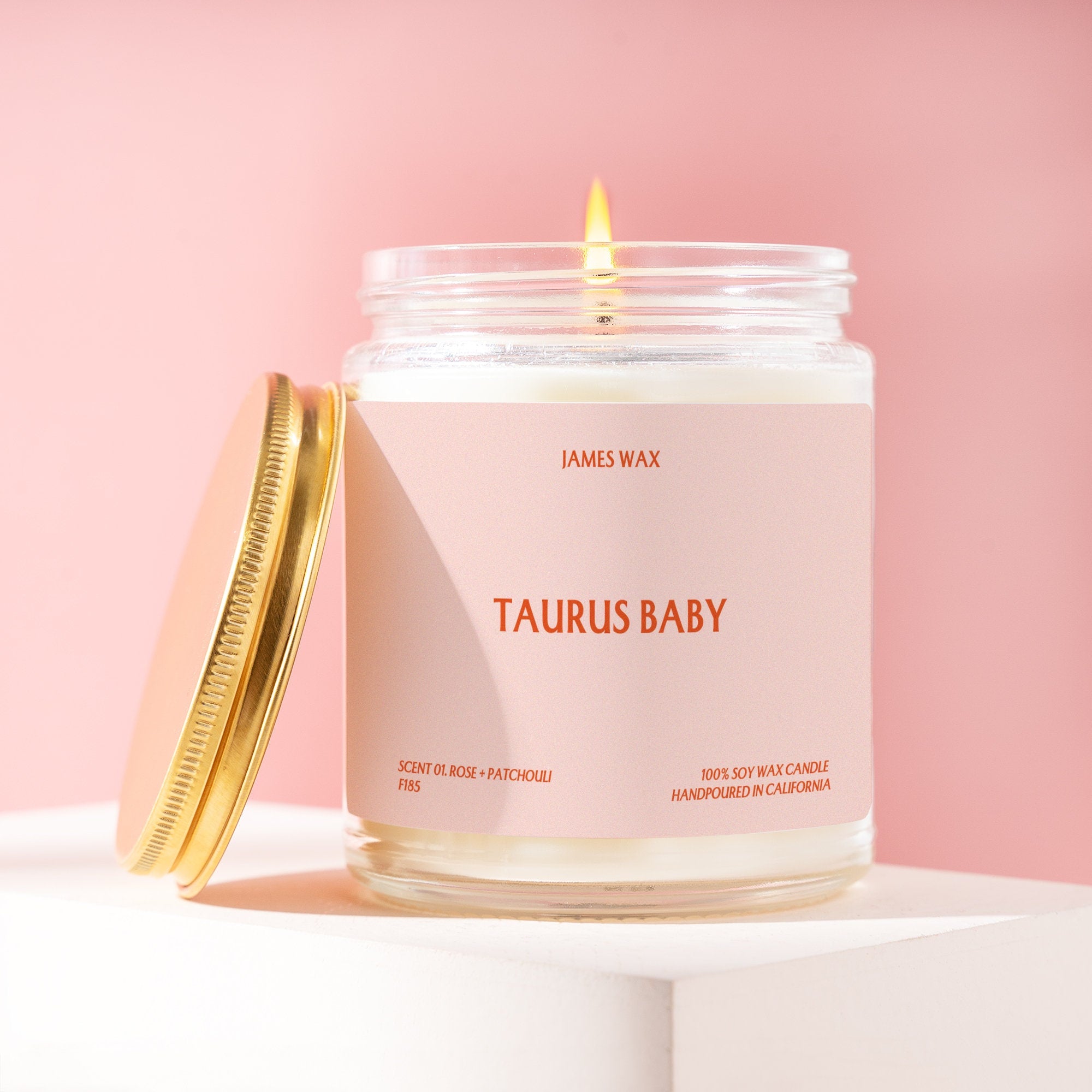 a jar of taurus baby candle on a white background